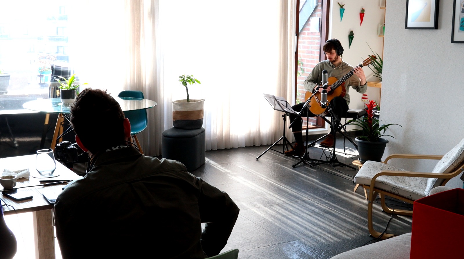 A guitarist playing in a living room during the recording of Deep