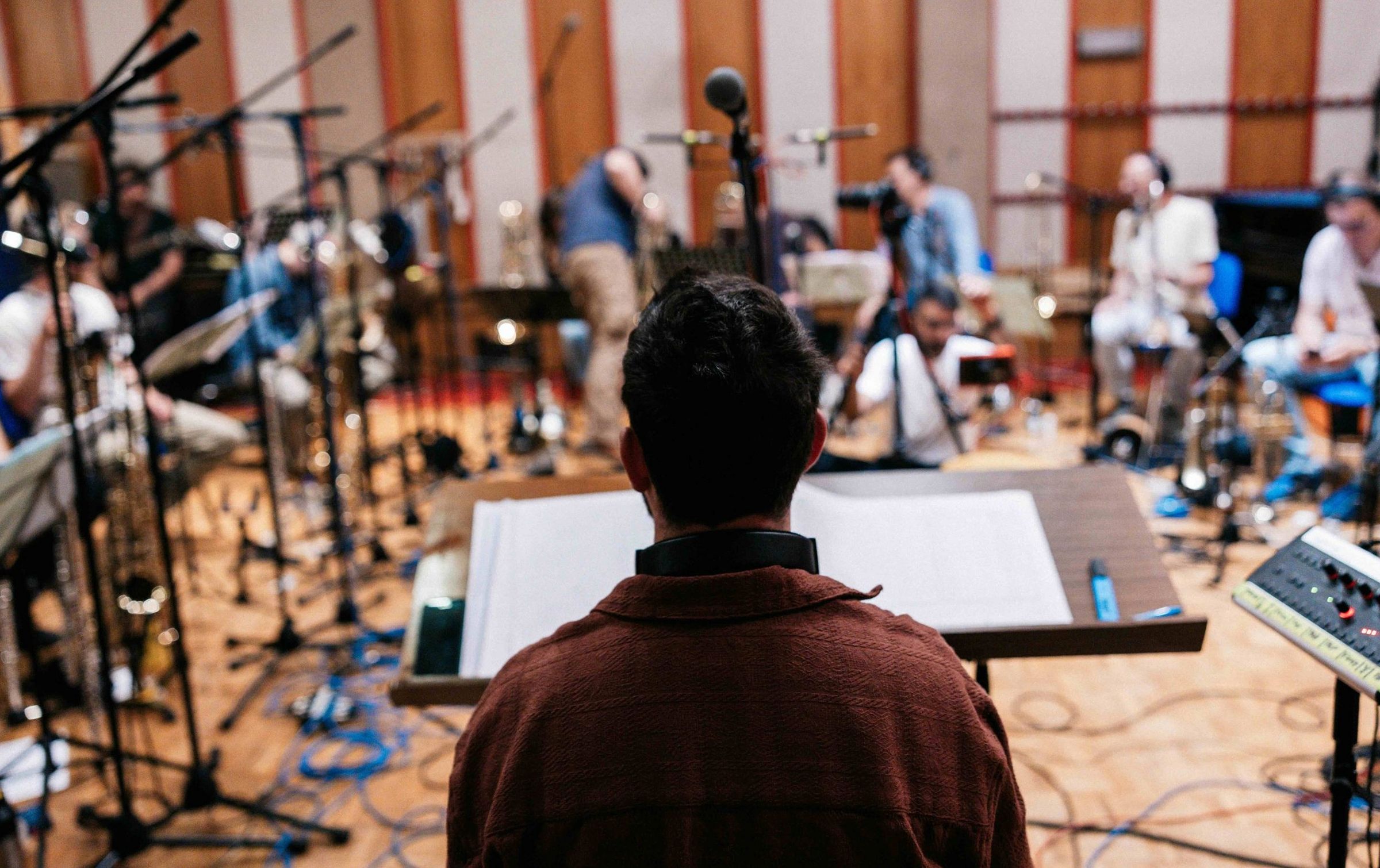 Gabriele di Franco conducting his jazz orchestra in the studio, seen from behind